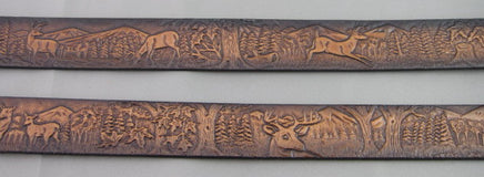 Detailed shot of embossed deer design on brown leather, highlighting handcrafted nature of the Gavere name belt.