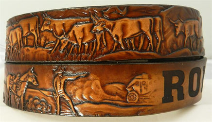 Kids custom cattle drive leather belt with personalized name and embossed cowboys and cattle in motion on brown leather.