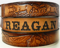 Custom kids leather belt with galloping horse design and engraved name panel, crafted from brown top-grain cowhide.