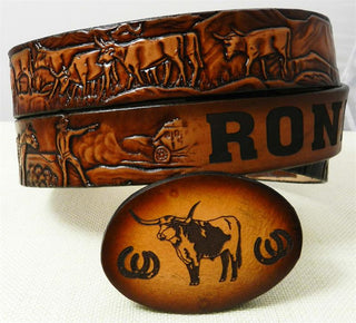 Complete kids cattle drive belt and buckle set with engraved western-themed buckle and embossed cowboy scene on leather.
