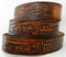 Close-up of custom leather trucker belt showing embossed semi-truck design and handcrafted detail on rich brown leather.