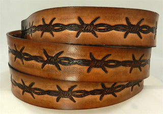 A tooled leather belt with a barbed wire pattern, featuring a buckle and made in brown color.