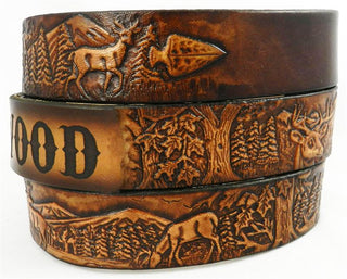 Personalized leather deer belt with engraved name and hand-tooled woodland scene featuring bucks in motion.