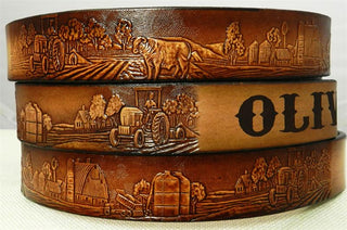 Children's personalized farm-themed leather belt with engraved name and embossed barn, tractor, and animal designs.